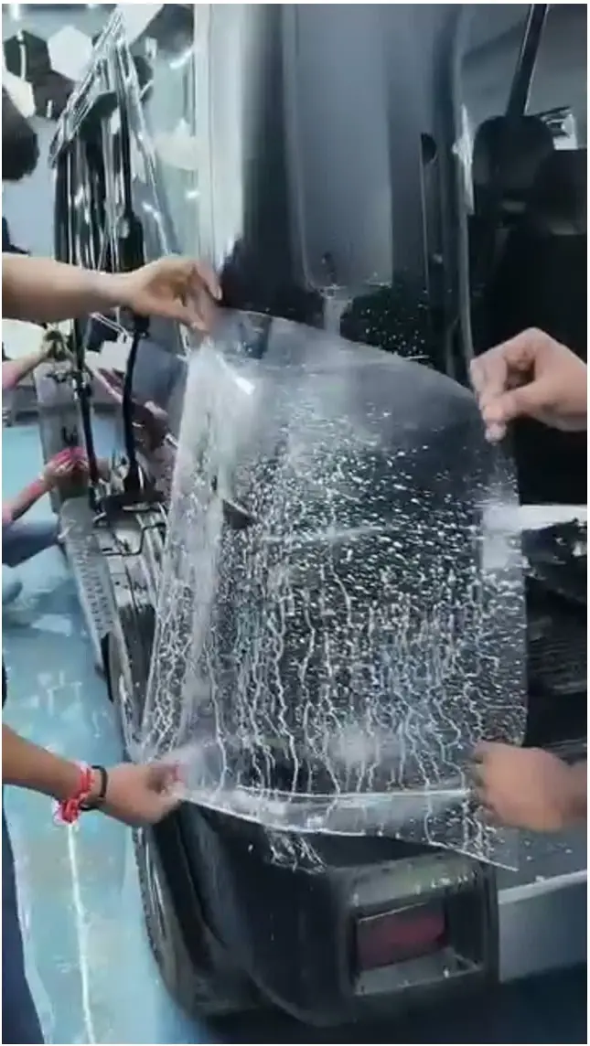 Film stretched by hand over a rear corner